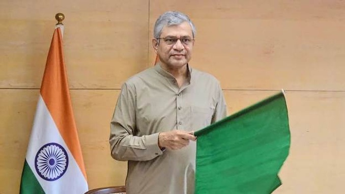 Railway Minister Ashwini Vaishnaw holds a green flag during the virtual inauguration of new Madhya Pradesh railway sections.